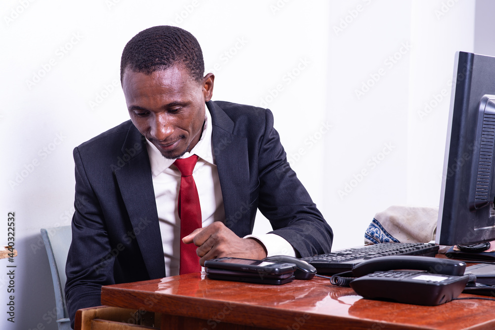 serious adult businessman looking for something in the desk drawer. serious adult businessman looking for something in the desk drawer.