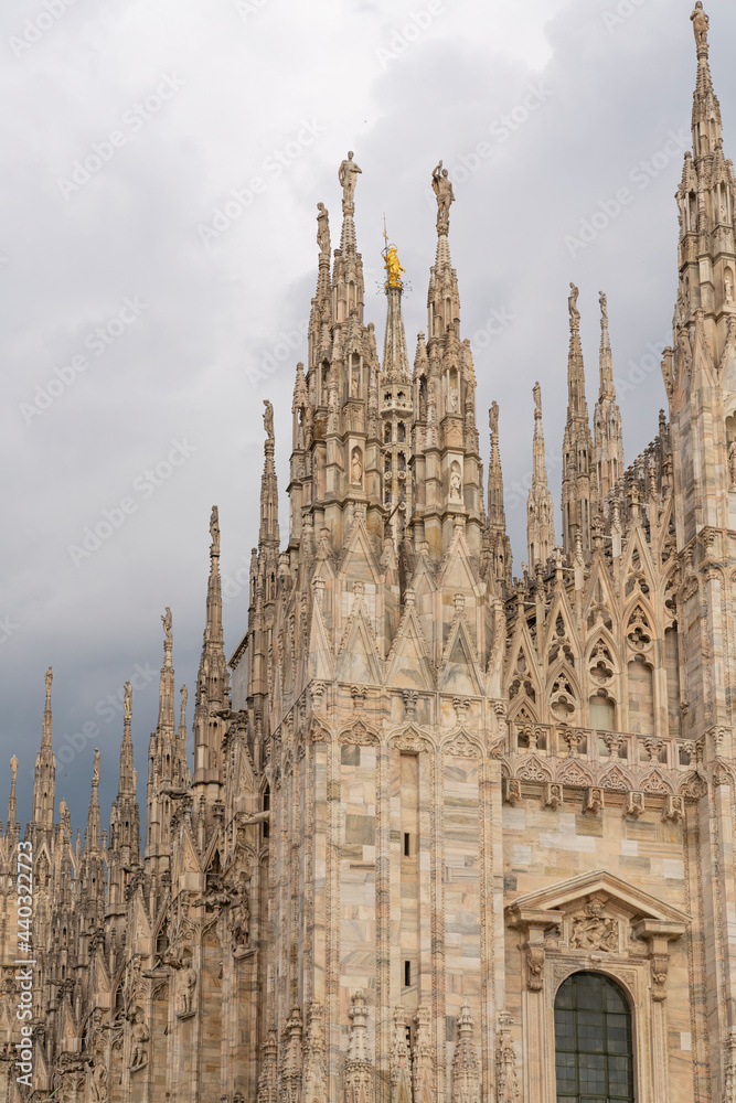 Details of Duomo with the golden statue name 