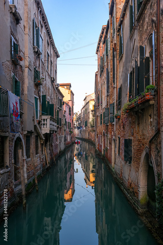 Venetian old Residential Waterfront Houses in green narrow Canal of Venice, Italy © Franz