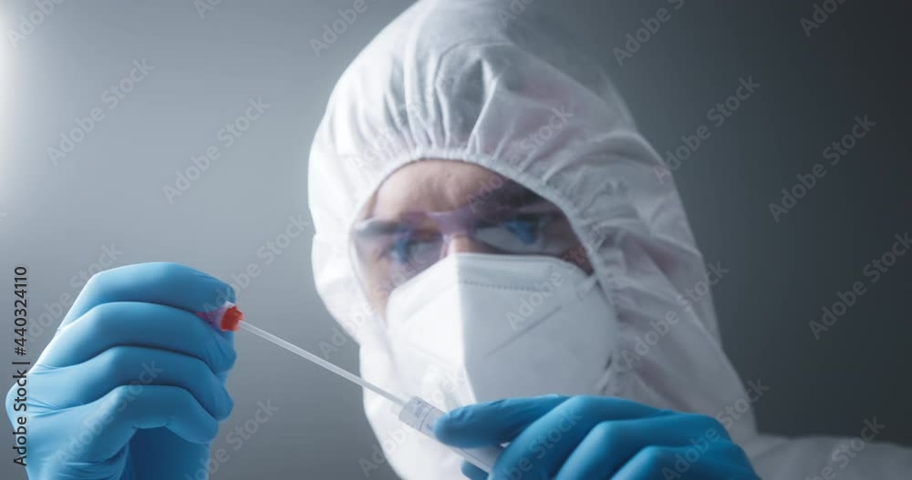 PCR DNA testing protocol process, Medical healthcare, technologist doctor holding COVID-19 swab collection kit, wearing PPE protective suit mask gloves, test tube for taking OP NP patient sample PCR DNA testing protocol process, Medical healthcare, technologist doctor holding COVID-19 swab collection kit, wearing PPE protective suit mask gloves, test tube for taking OP NP patient sample