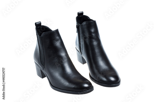 Ladies fashionable black boots, isolated on white background © Georgi