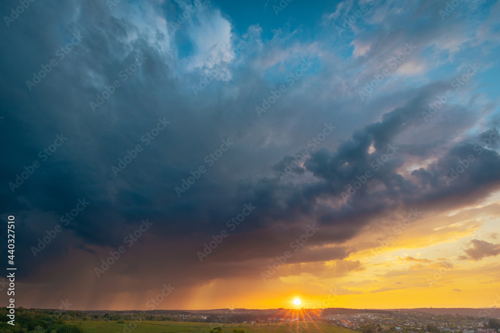 A beautiful sunset sky with stormy rainy sky panoramic view. Breathtaking moment of oncoming rain.