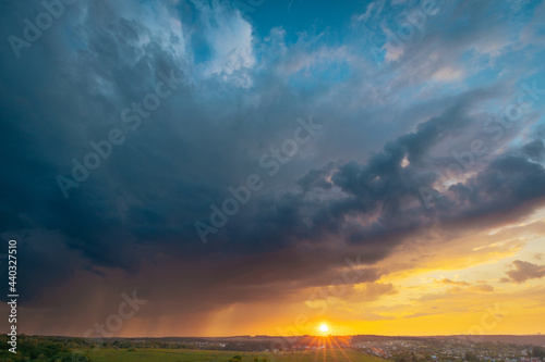 A beautiful sunset sky with stormy rainy sky panoramic view. Breathtaking moment of oncoming rain.