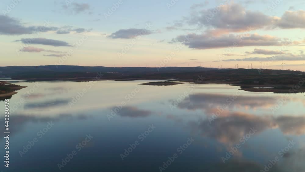 Drone aerial view of a lake reservoir of a dam with perfect reflection on the water of the sunset in Sabugal, Portugal Drone aerial view of a lake reservoir of a dam with perfect reflection on the water of the sunset in Sabugal, Portugal