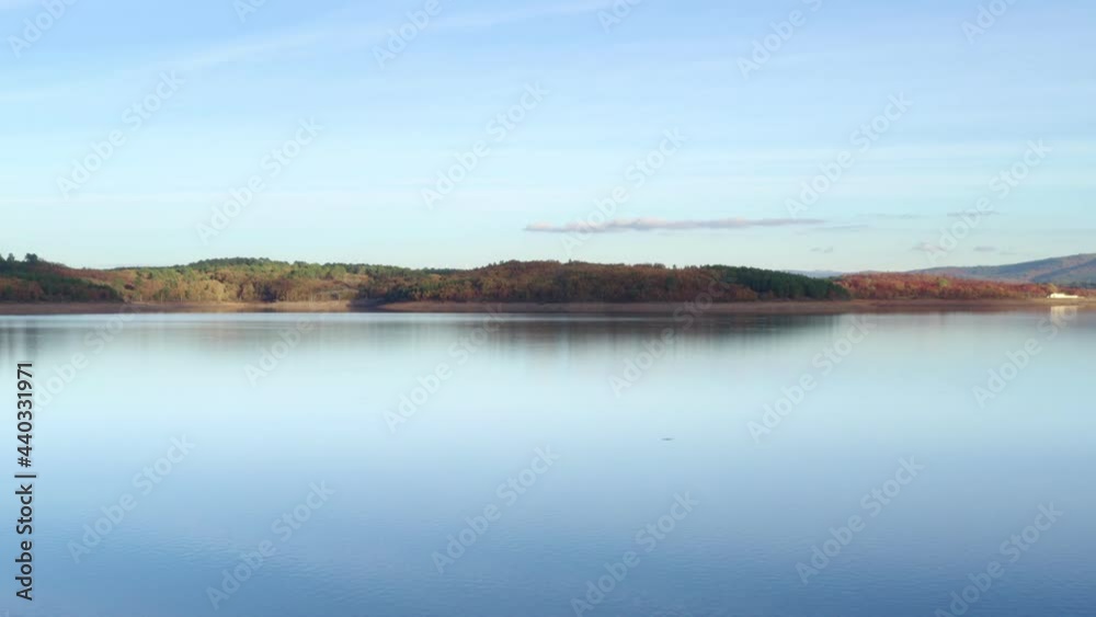Drone aerial view of a lake reservoir of a dam with perfect reflection on the water of the sunset in Sabugal, Portugal Drone aerial view of a lake reservoir of a dam with perfect reflection on the water of the sunset in Sabugal, Portugal