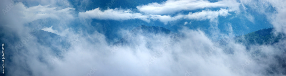The fog rises over the mountains after the rain The fog rises over the mountains after the rain