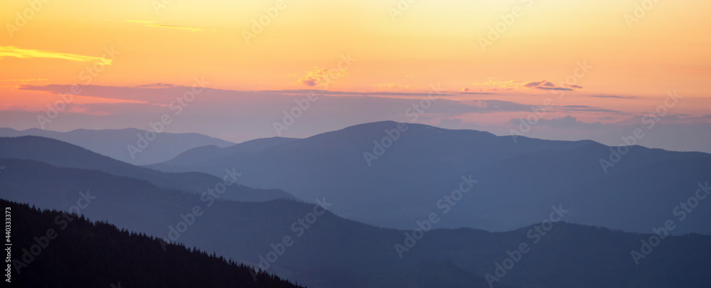 Amazing mountain landscape with colorful vivid sunset on the cloudy sky, natural outdoor travel background