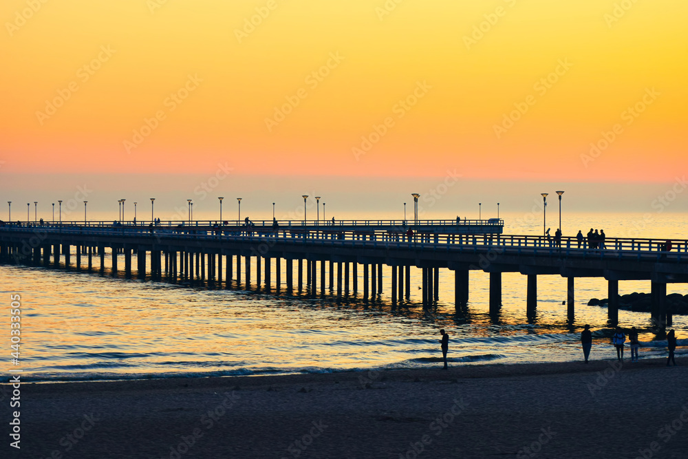 Obraz premium Dramatic colorful sunset at famous marine pier in Baltic resort city of Palanga. Lithuania landmarks
