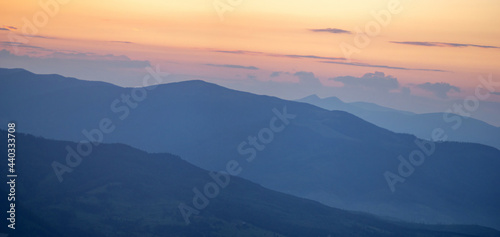 Colorful silhouettes of mountains at sunset in summer © onyx124