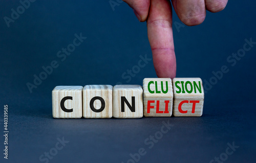 Conflict or conclusion symbol. Businessman turns wooden cubes, changes the word 'conflict' to 'conclusion'. Beautiful grey background, copy space. Business, conflict or conclusion concept.
