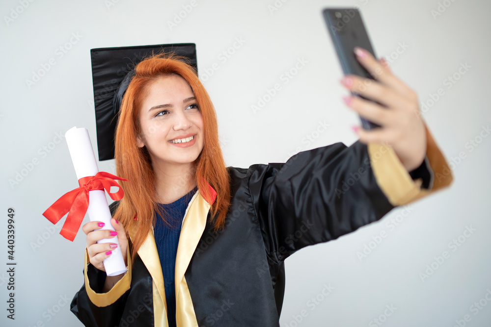 female graduate holding diploma