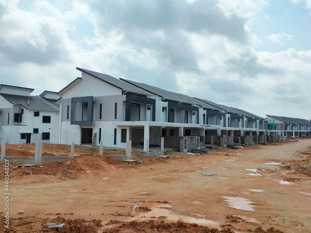 SEREMBAN, MALAYSIA -JUNE 17, 2021: New double-story terrace house under construction in Malaysia. Designed by an architect with a modern and contemporary style. Almost completed. SEREMBAN, MALAYSIA -JUNE 17, 2021: New double-story terrace house under construction in Malaysia. Designed by an architect with a modern and contemporary style. Almost completed.