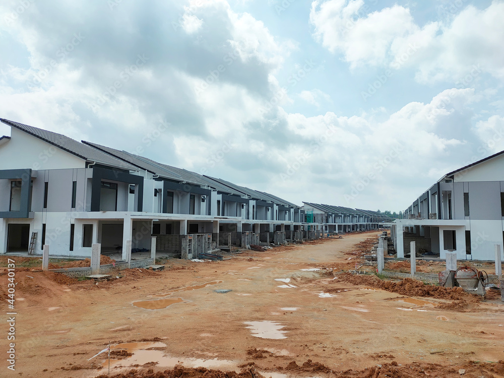 SEREMBAN, MALAYSIA -JUNE 17, 2021: New double-story terrace house under construction in Malaysia. Designed by an architect with a modern and contemporary style. Almost completed. SEREMBAN, MALAYSIA -JUNE 17, 2021: New double-story terrace house under construction in Malaysia. Designed by an architect with a modern and contemporary style. Almost completed.