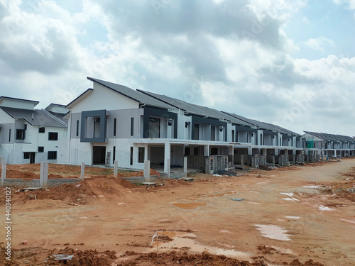 SEREMBAN, MALAYSIA -JUNE 17, 2021: New double-story terrace house under construction in Malaysia. Designed by an architect with a modern and contemporary style. Almost completed.   © Aisyaqilumar