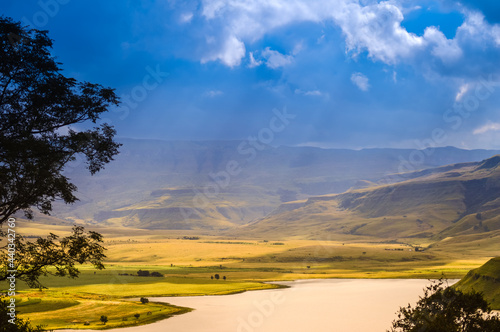 Drakensberg mountains and bell park dam with solar flare during sunset in KZN photo