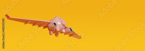 Photos Piggy bank with airplane wings flying on yellow background with copy space