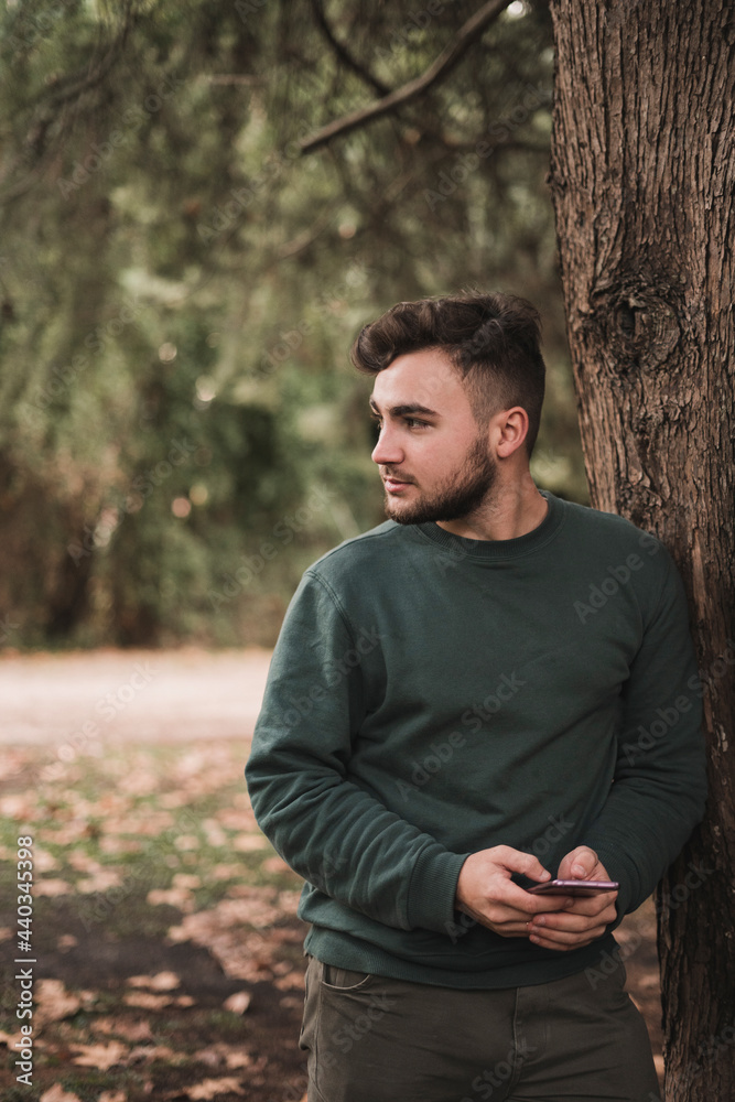 Portrait of a young Caucasian man in a park