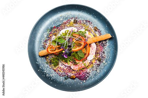 Salad on a black plate isolated on a white background. A dish from the chef. 