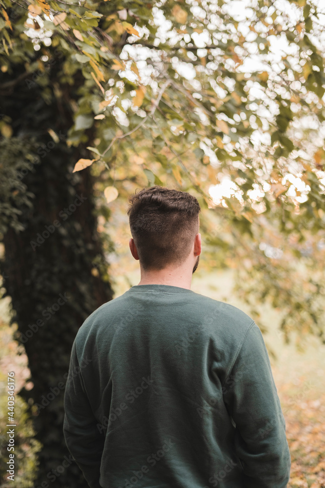 Portrait of a young handsome Caucasian man in a park Portrait of a young handsome Caucasian man in a park