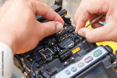 Communication system technician checks the data line connection Cable technology Fiber Optic Fusion Splicing Internet Signal and Cabling with Fiber Optic Fusion Splicing Machine Fiber Optic Splicing M photo