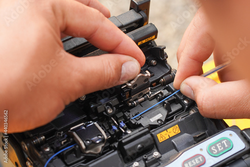 Communication system technician checks the data line connection Cable technology Fiber Optic Fusion Splicing Internet Signal and Cabling with Fiber Optic Fusion Splicing Machine Fiber Optic Splicing M photo