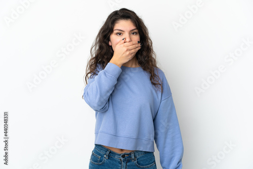 Teenager Russian girl isolated on white background covering mouth with hand © luismolinero