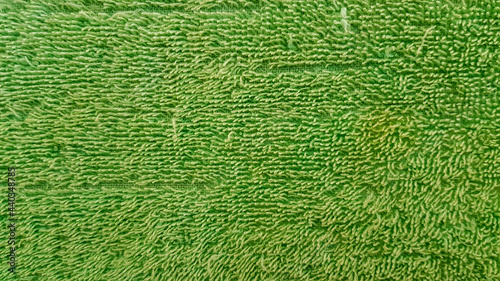 green old towel texture for background The fabric or textile is made up of cotton fiber material, looks fluffy, dry, soft.