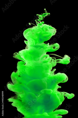 Green paint in water isolated on black background