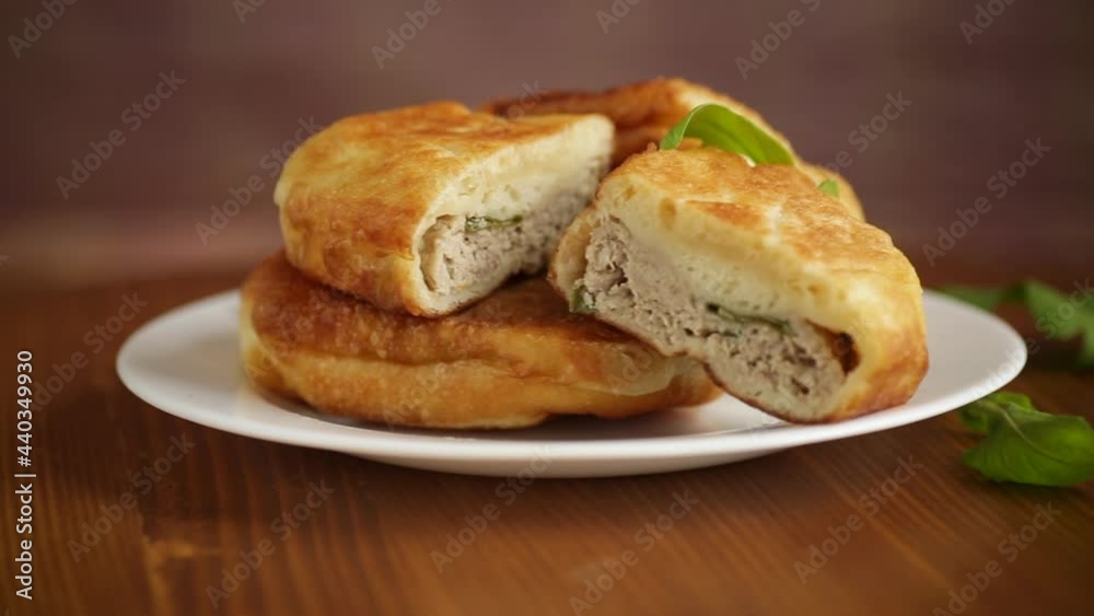 fried pies with meat in a plate on a white fried pies with meat in a plate on a white