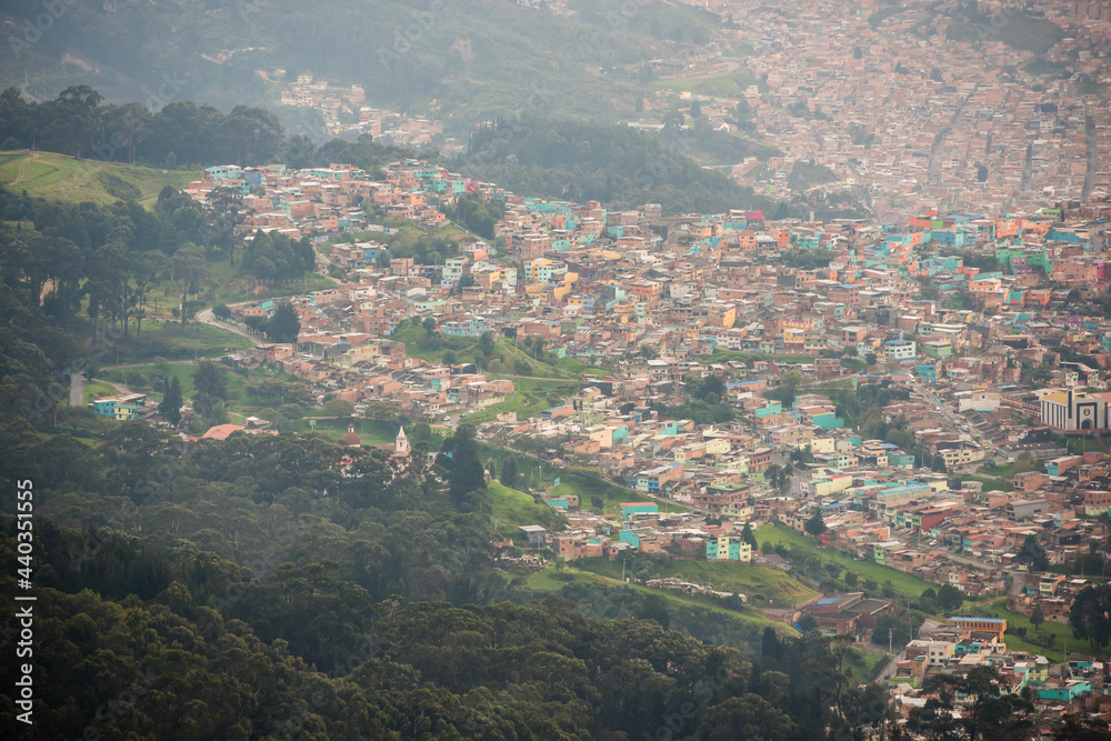 View of many pastel homes from the top of Mount Montserrate in Bogota Colombia.