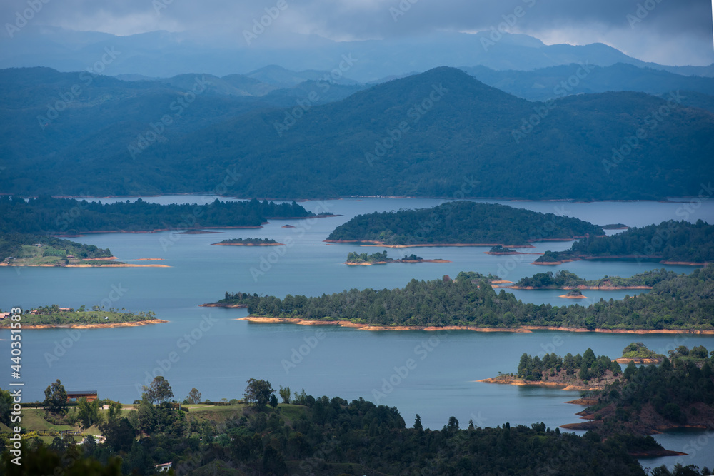 View at the top of El Penon de Guatape looking out at layers of beautiful land water and terrain.