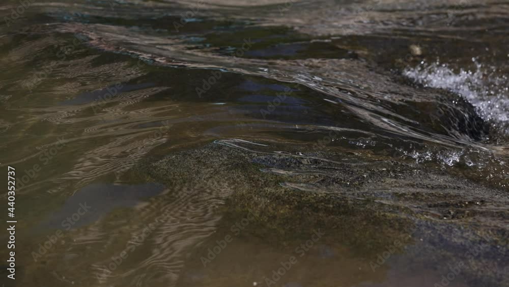 Slow motion river flows over rocks into tiny rapids area. Slow motion river flows over rocks into tiny rapids area.