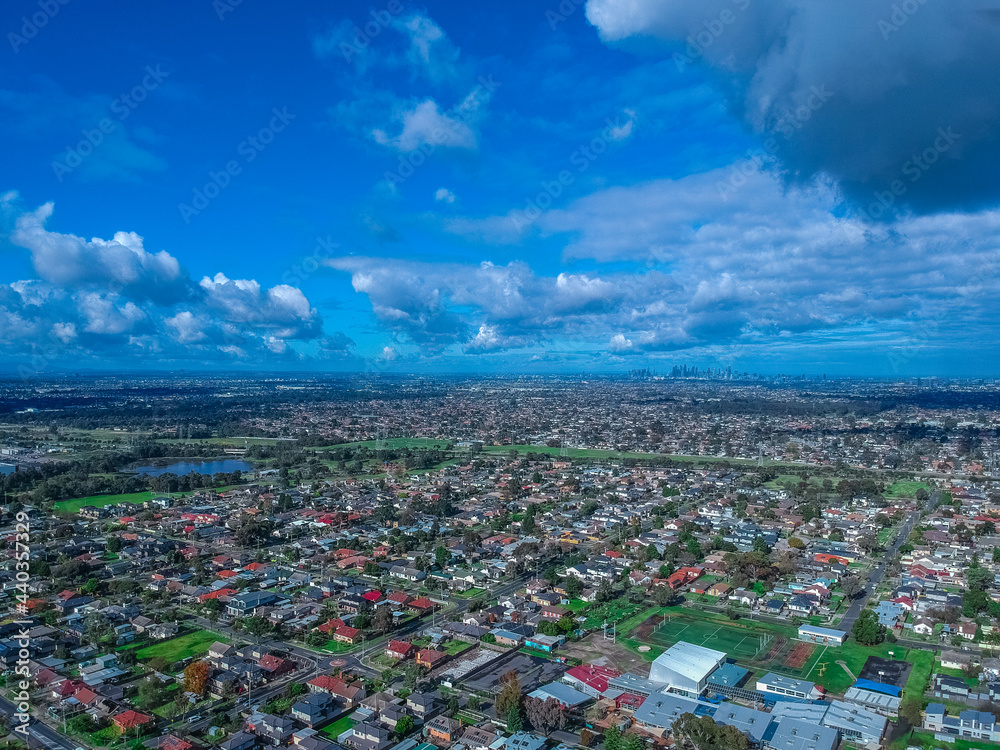 Panoramic aerial view of Melbournes western suburbs and CBD looking down at Houses roads and Parks Victoria Panoramic aerial view of Melbournes western suburbs and CBD looking down at Houses roads and Parks Victoria