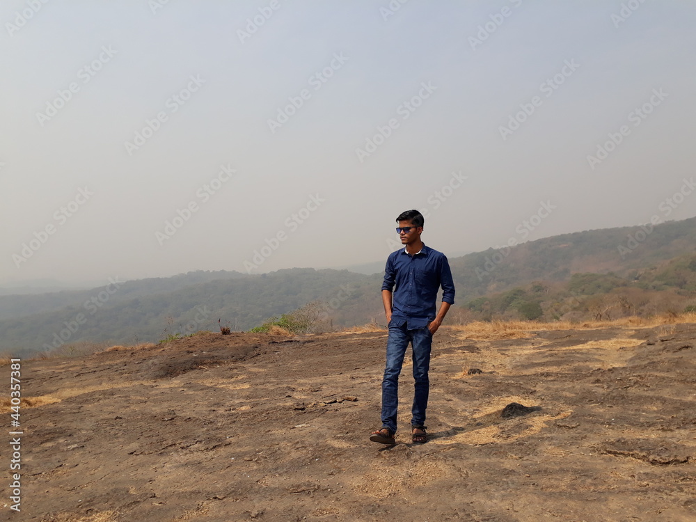 man standing on the top of the mountain, man in the mountains, young boy hiking in the mountains, Sanjay Gandhi National Park.