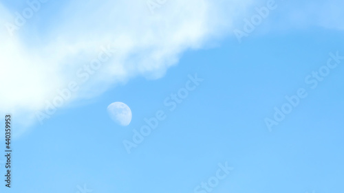 Moon and cloud on a blue sky.