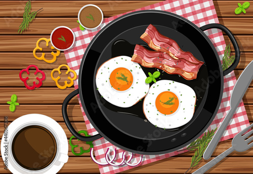 Top view of breakfast meal with fried eggs and bacon in a pan on the table background
