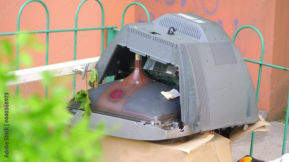 Broken tv in the trash can in 4k slow motion 60fps StockVideo Adobe