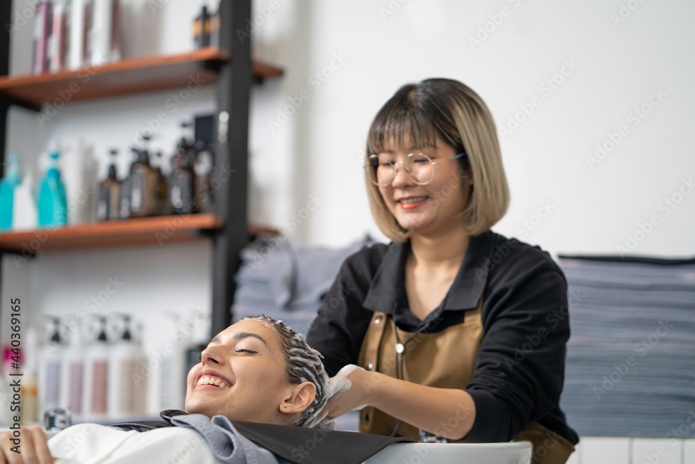 Beautiful Caucasian women feel relax and comfortable while getting hair wash with shampoo and massage. Hair salon studio with hair stylish, beauty and fashion concept. Beautiful Caucasian women feel relax and comfortable while getting hair wash with shampoo and massage. Hair salon studio with hair stylish, beauty and fashion concept.