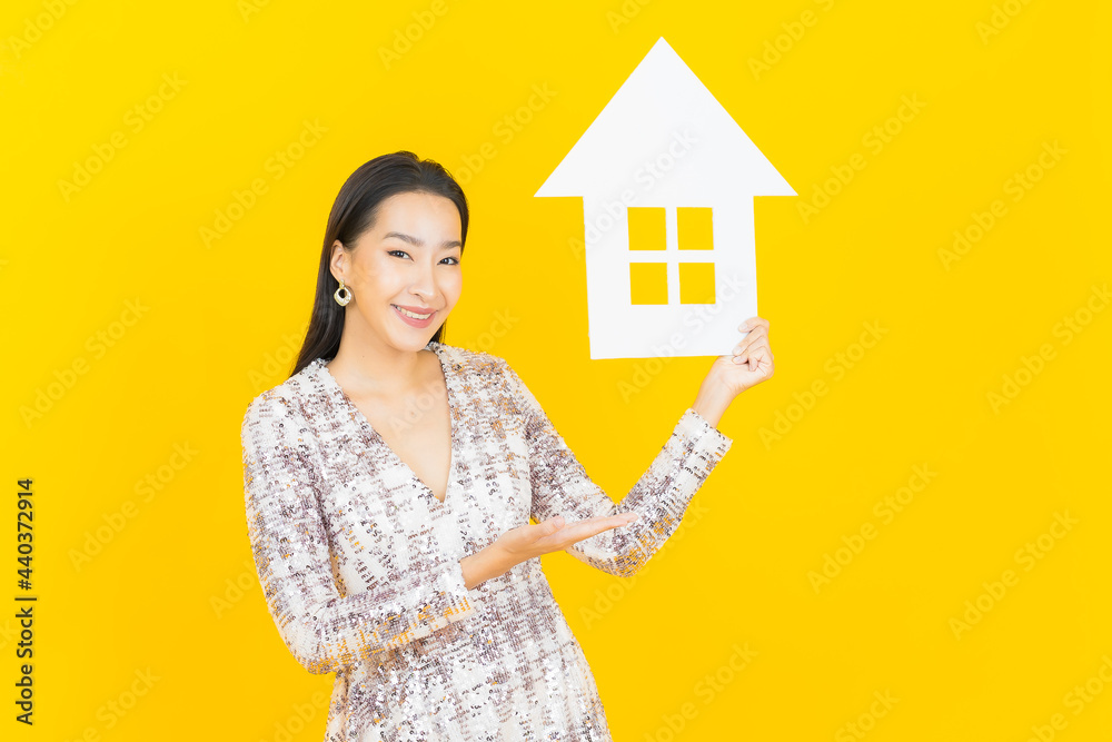 Portrait beautiful young asian woman with house or home paper sign Portrait beautiful young asian woman with house or home paper sign