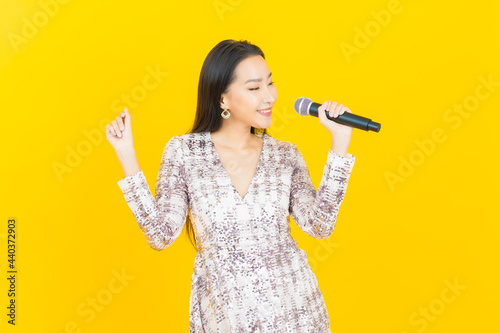 Portrait beautiful young asian woman with microphone for singing