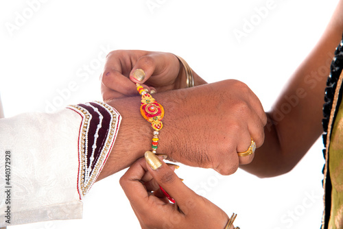 Indian festival Raksha Bandhan, Raakhi on hand, Sister tie Rakhi as symbol of intense love for her brother. photo