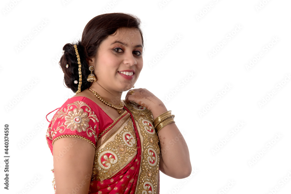 Beautiful young girl posing in Indian traditional saree on white background. Beautiful young girl posing in Indian traditional saree on white background.