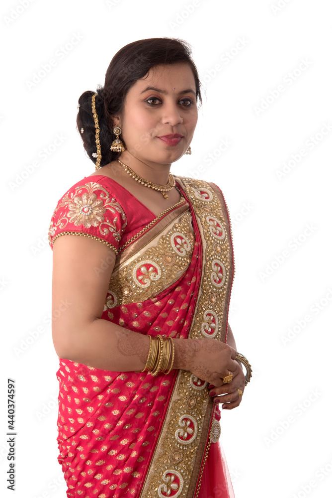 Beautiful young girl posing in Indian traditional saree on white background. Beautiful young girl posing in Indian traditional saree on white background.