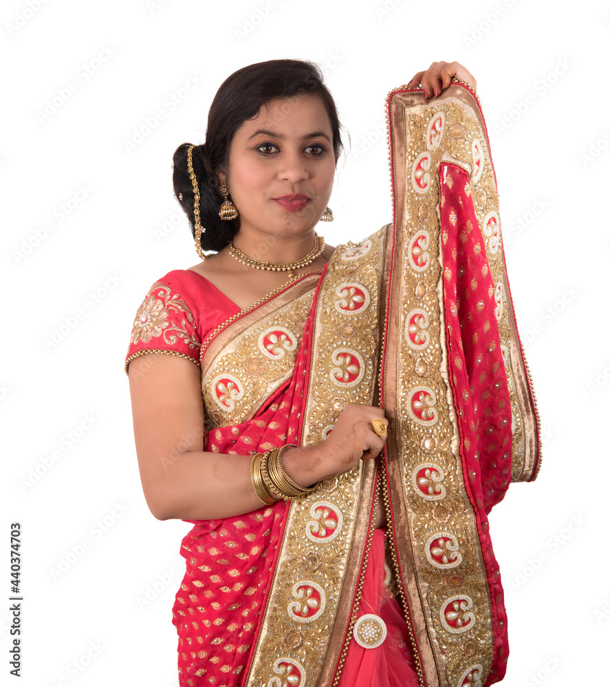 Beautiful young girl posing in Indian traditional saree on white background. Beautiful young girl posing in Indian traditional saree on white background.