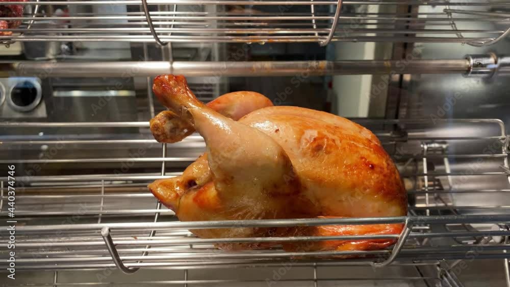 Rotating machine are grilled whole chicken. Roasted chickens in a row ...