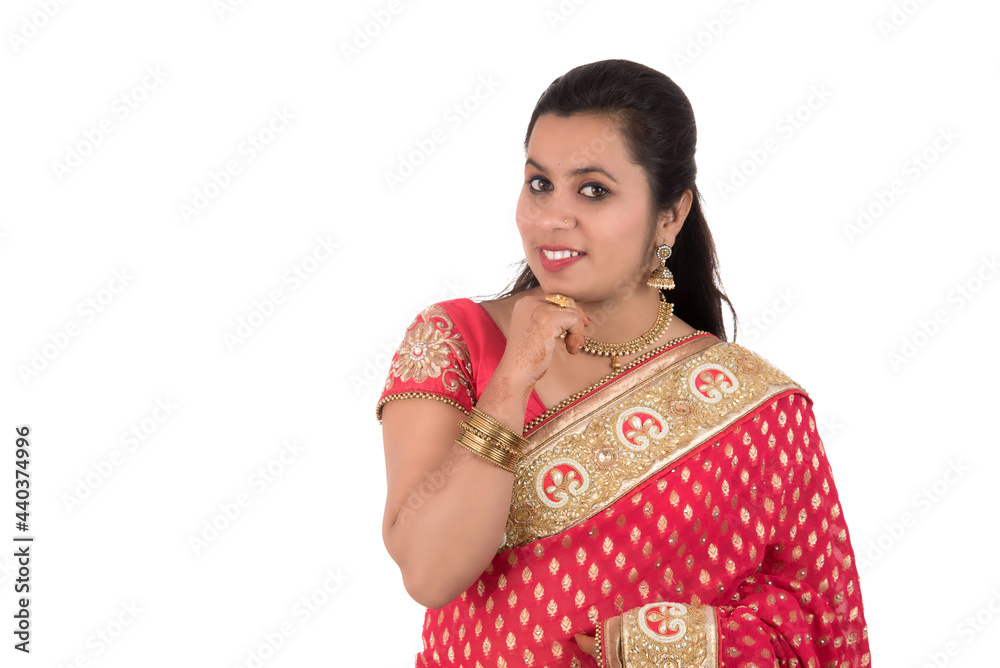 Beautiful young girl posing in Indian traditional saree on white background. Beautiful young girl posing in Indian traditional saree on white background.