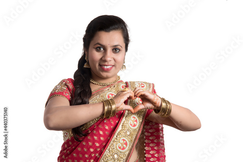 Beautiful young girl posing in Indian traditional saree on white background.