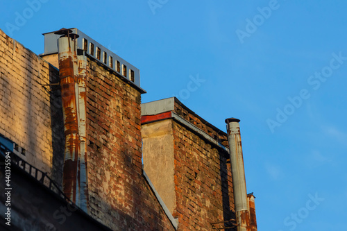 Chimneys on the roofs of old buildings in St. Petersburg.