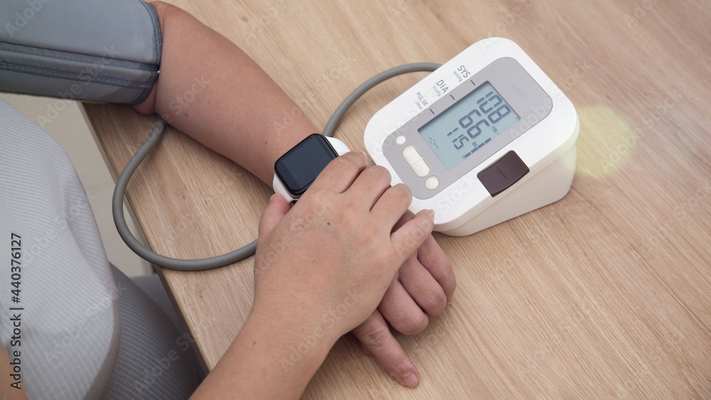 Female blood pressure.and heart rate with digital pressure gauge standard blood pressure test results .Health and Medical concept Female blood pressure.and heart rate with digital pressure gauge standard blood pressure test results .Health and Medical concept