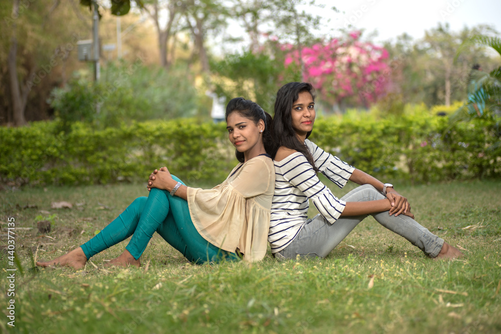 Two young girl friends having fun together in outdoors. Looking at camera. Two young girl friends having fun together in outdoors. Looking at camera.